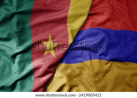 big waving national colorful flag of armenia and national flag of cameroon . macro