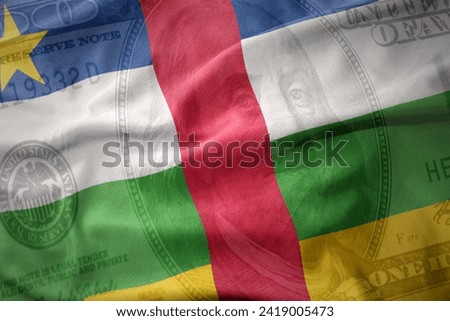 waving colorful national flag of central african republic on a american dollar money background. finance concept.