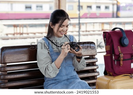 Young Asian woman backpack traveler using a camera. Journey trip lifestyle. travel concept