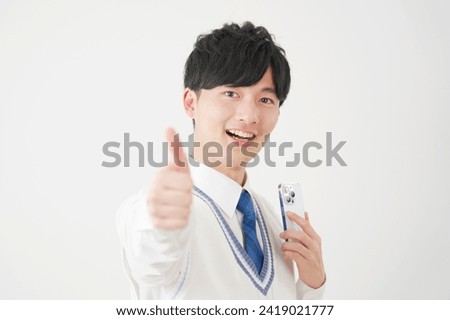 Asian high school boy with the smartphone thumbs up gesture in white background