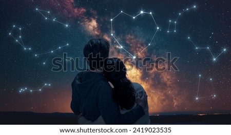A couple in love looking at the starry sky. A fantasy constellation in the shape of a heart.