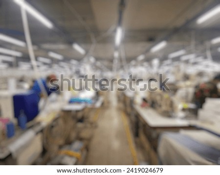 Blurred image of Employees are sewing shirts in​ the​ garment​ factory​ Thailand.​Background blur. Royalty-Free Stock Photo #2419024679