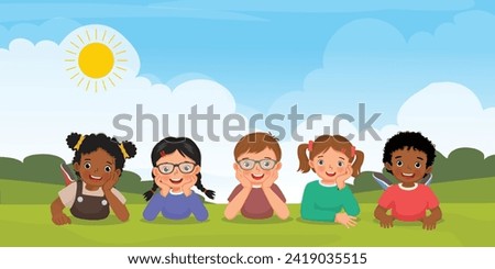 Group of multi ethnic kids lying on the grass together