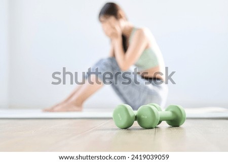 A woman feels depressed because her home training doesn't go well Royalty-Free Stock Photo #2419039059