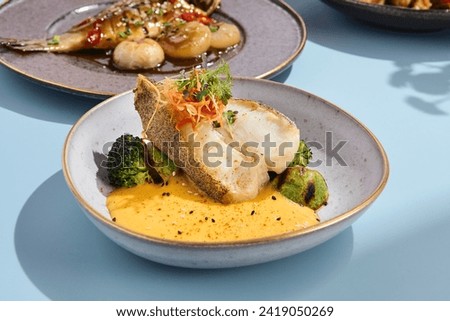 Halibut steak with pumpkin puree and broccoli, ideal for a vibrant summer menu in a high-end eatery.