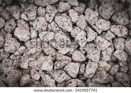 Close-up texture of a rough stone surface. Stone background with vignetted.