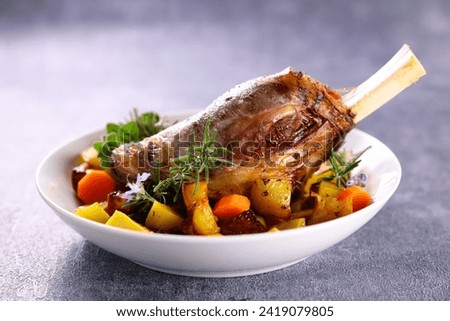 baked lamb leg with potatoes and carrots Royalty-Free Stock Photo #2419079805
