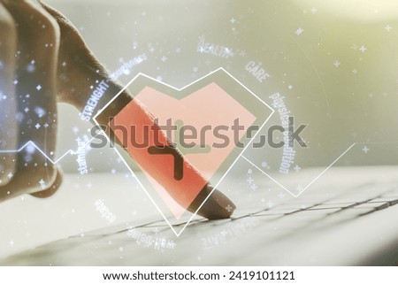 Creative concept of heart pulse illustration and hands typing on laptop on background. Medicine and healthcare concept. Multiexposure