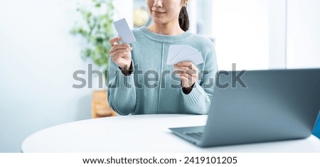 A woman worried about credit cards Royalty-Free Stock Photo #2419101205