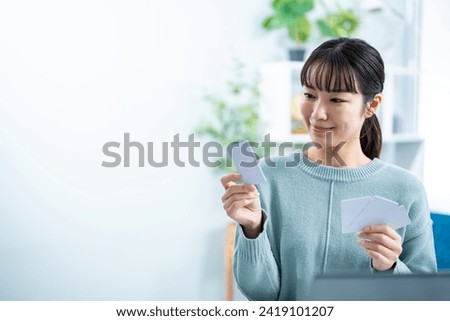 A woman worried about credit cards Royalty-Free Stock Photo #2419101207