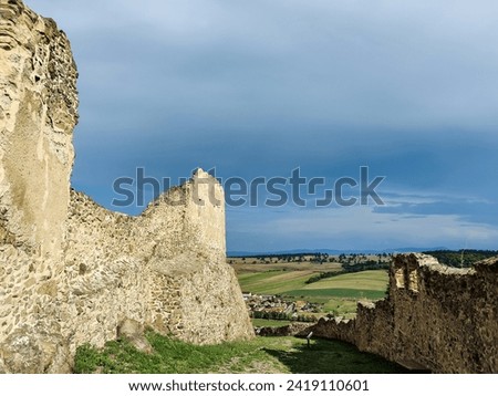 Scenic view of ancient Rupea fortress in Romania against blue sky with clouds. Citadel Rupea. Fortress was built on ruins of former Dacian defensive structure. Copy space. Selective focus. Royalty-Free Stock Photo #2419110601