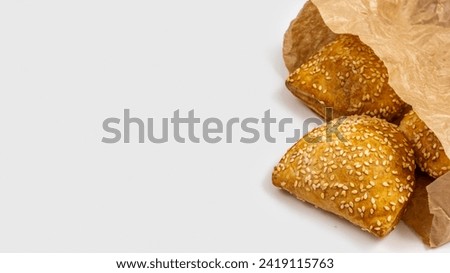 Traditional Israeli pastry Bourekas with cheese on white background with copy space. Royalty-Free Stock Photo #2419115763