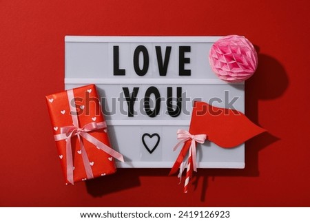 Chalkboard with the words "I love you" on a red background.
