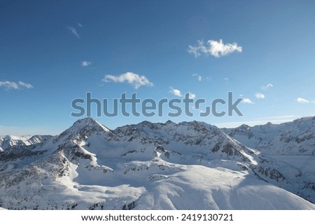 Sunny mountains peaks in winter Alps.