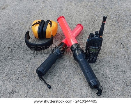 equipment for Marshaller. Earmuv, Parking stick and Radio Royalty-Free Stock Photo #2419144405