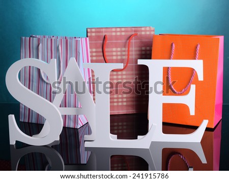 Sale with bags on colorful background