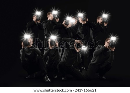 Group of photographers with cameras on black background. Paparazzi Royalty-Free Stock Photo #2419166621