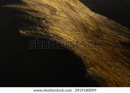 golden ink painted on black background