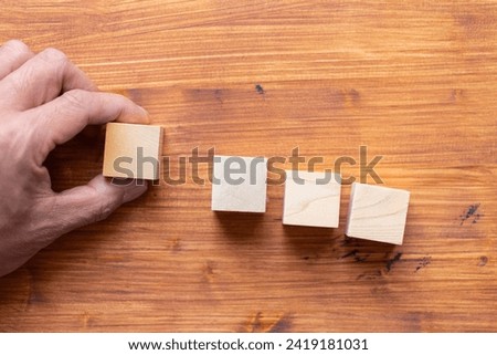 person's hand holding blank block