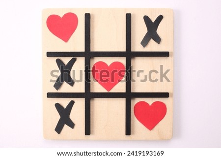 Valentine's day concept with hearts Tic Tac game on white background. Top view