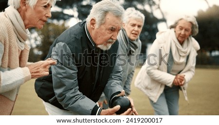 Senior man, game and senior people bowling in nature for retirement sports, teamwork and support. Bowling, friends and elderly man and woman in a group with a ball for a competition on a field togeth