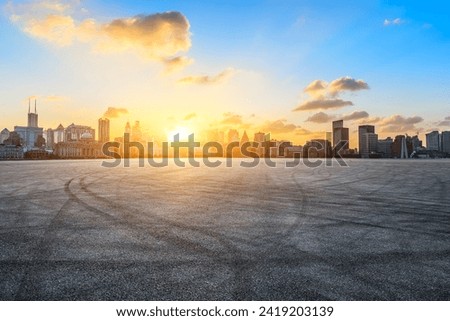 Asphalt road square with city skyline at sunset in Shanghai