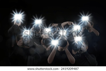 Group of photographers with cameras on black background. Paparazzi