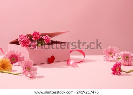 Cute pink background with gerberas and fresh carnations decorated. Sweet and romantic women's day decoration ideas. Empty space for product presentation, front view Royalty-Free Stock Photo #2419217475
