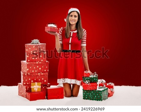 Female Santa holding pile of presents over a red background.
