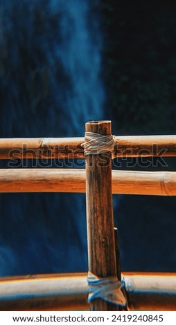 bamboo fence with waterfall background