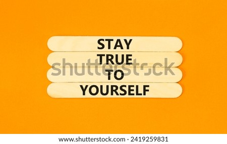 Stay true to yourself symbol. Concept word Stay true to yourself on beautiful wooden stick. Beautiful orange table orange background. Business stay true to yourself concept. Copy space.