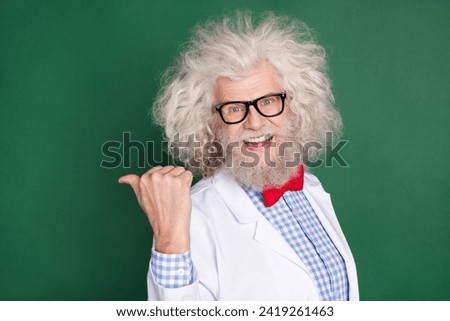 Photo of excited positive man indicate thumb empty space feedback tips offer isolated on dark green color background