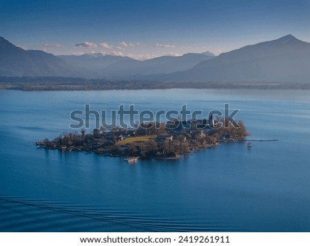 Small island from above, aerial view at Chiemsee lake in winter