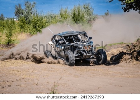 UTV vehicle offroad kicking up sand on a dune. Extreme, adrenalin. 4x4. Royalty-Free Stock Photo #2419267393