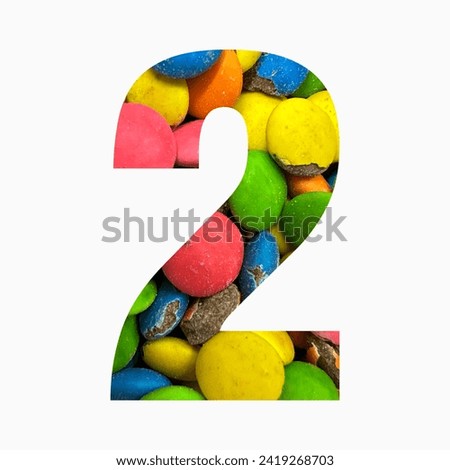Number two of colourful candies and paper cut in shape of second digit isolated on white. Rainbow typeface