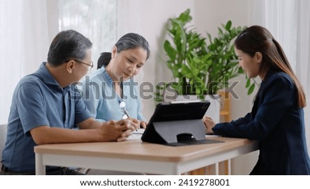 Financial advisor,realtor agent,insurance,lawyer,Manage your retirement fund concept.Financial advisor showing presentation on computer,deal shake hand to happiness Elderly asian couple retirement Royalty-Free Stock Photo #2419278001