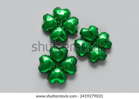 Balloons in shape of clover on grey background. St. Patrick's Day celebration