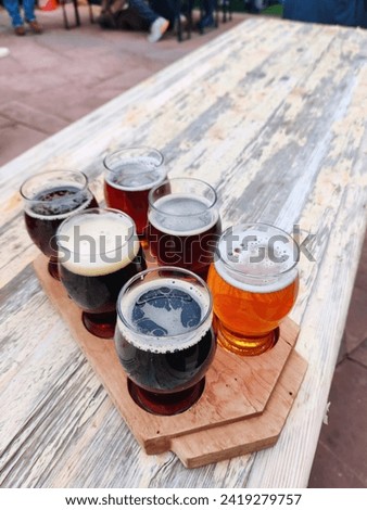 Beer samples on beer garden outside restaurant table drink background texture close up photo with copy space. Biergarten, brewery, pub, bar or taproom.