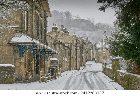 Winter street scene in Settle North Yorkshire with snow Royalty-Free Stock Photo #2419283257