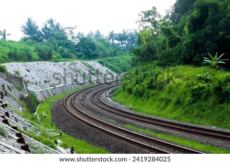 photo of a two-track railroad with sharp bends
