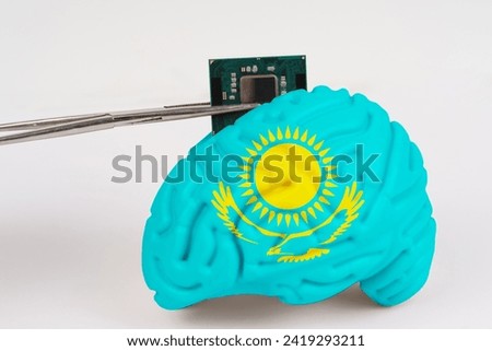 On a white background, a model of the brain with a picture of a flag - Kazakhstan, a microcircuit, a processor, is implanted into it. Close-up