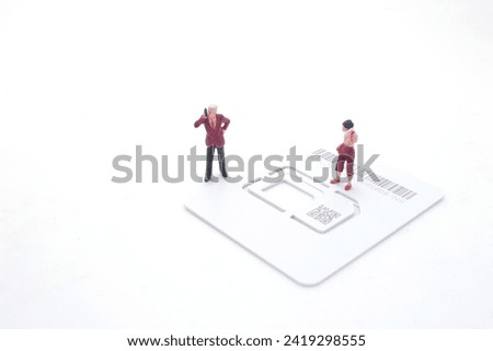 Talking on the phone, the figure stand on the sim card