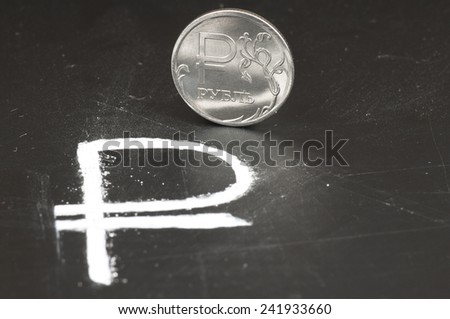 Russian ruble, sign and coin on the blackboard