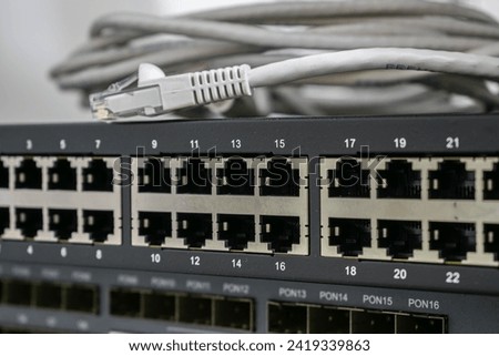There is a close-up of an Internet communication switch with many empty ports. Interfaces for connecting cable Internet lines