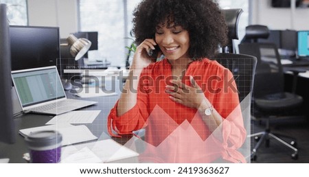 Image of financial data with icons over african american businesswoman in office. Global business, finances, computing and data processing concept digitally generated image.