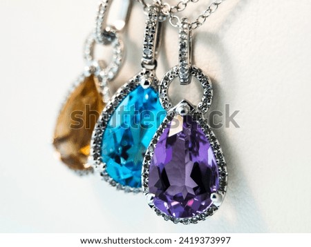 Birthstone gemstone pendants on display. Royalty-Free Stock Photo #2419373997