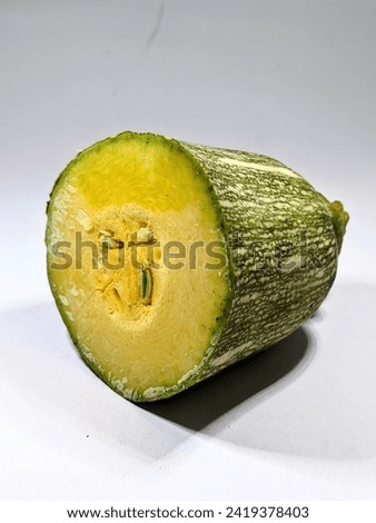A piece of sliced raw pumpkin placed on a white background 