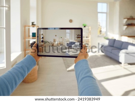 Hands holding device, taking room interior design picture with tablet, perfect view for rent, sell apartment. Photographing rental property, attractive viewing, real estate space representation 