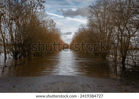 The flooded floodplains and the many hiking trails during weeks of heavy downpour, caused by climate change, near the rain river IJssel in the province of Overijssel, the Netherlands Royalty-Free Stock Photo #2419384727