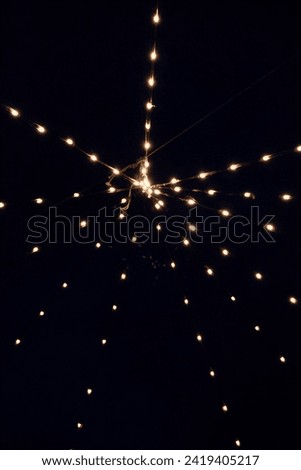 Lighting with small bulbs under a clear sky on a winter night in the Umbria region.